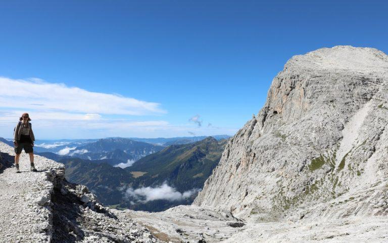 woman during a high mountain hike on the Italian Dolomite in summer on the stony path